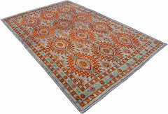 Handmade Afghan Pashm wool rug featuring a traditional tribal pattern in orange and blue tones.