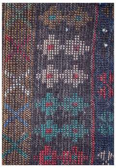 Handmade Afghan Pashm rug featuring geometric diamond patterns in red, blue, and ivory on dark wool.
