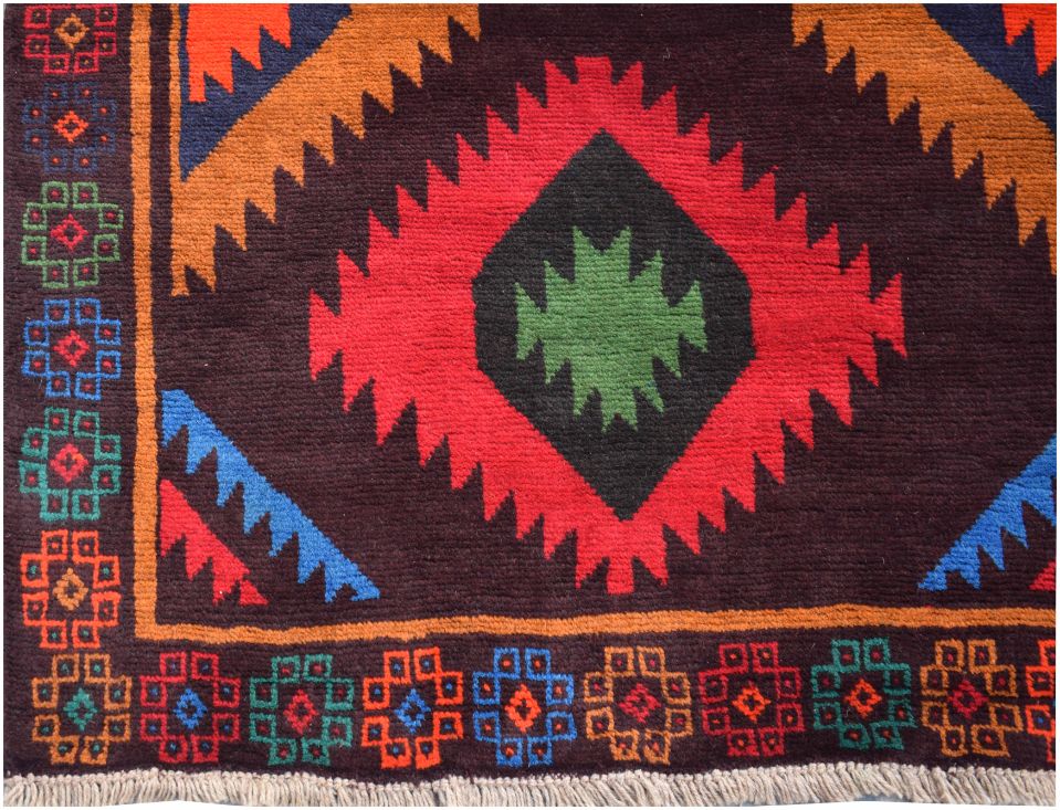 Handmade Afghan wool rug featuring a dark brown background with vibrant geometric tribal patterns.