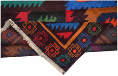 A handmade Afghan wool rug featuring colorful geometric patterns and a fringed edge.