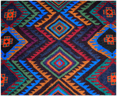 Handmade Afghan Pashm rug featuring a geometric diamond pattern in vibrant red, blue, and green.