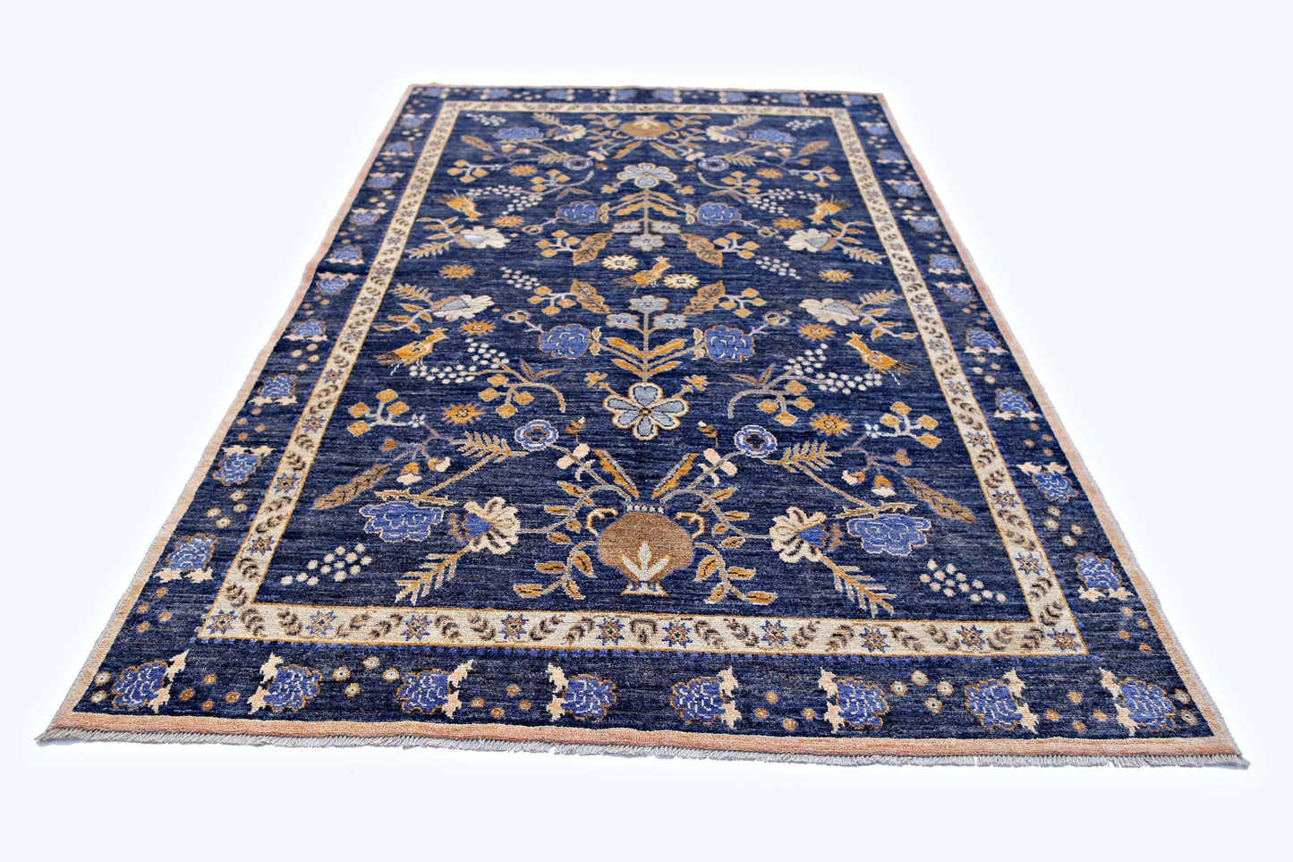 Handmade Afghan Pashm wool rug featuring a floral pattern in blue, tan, and cream tones.