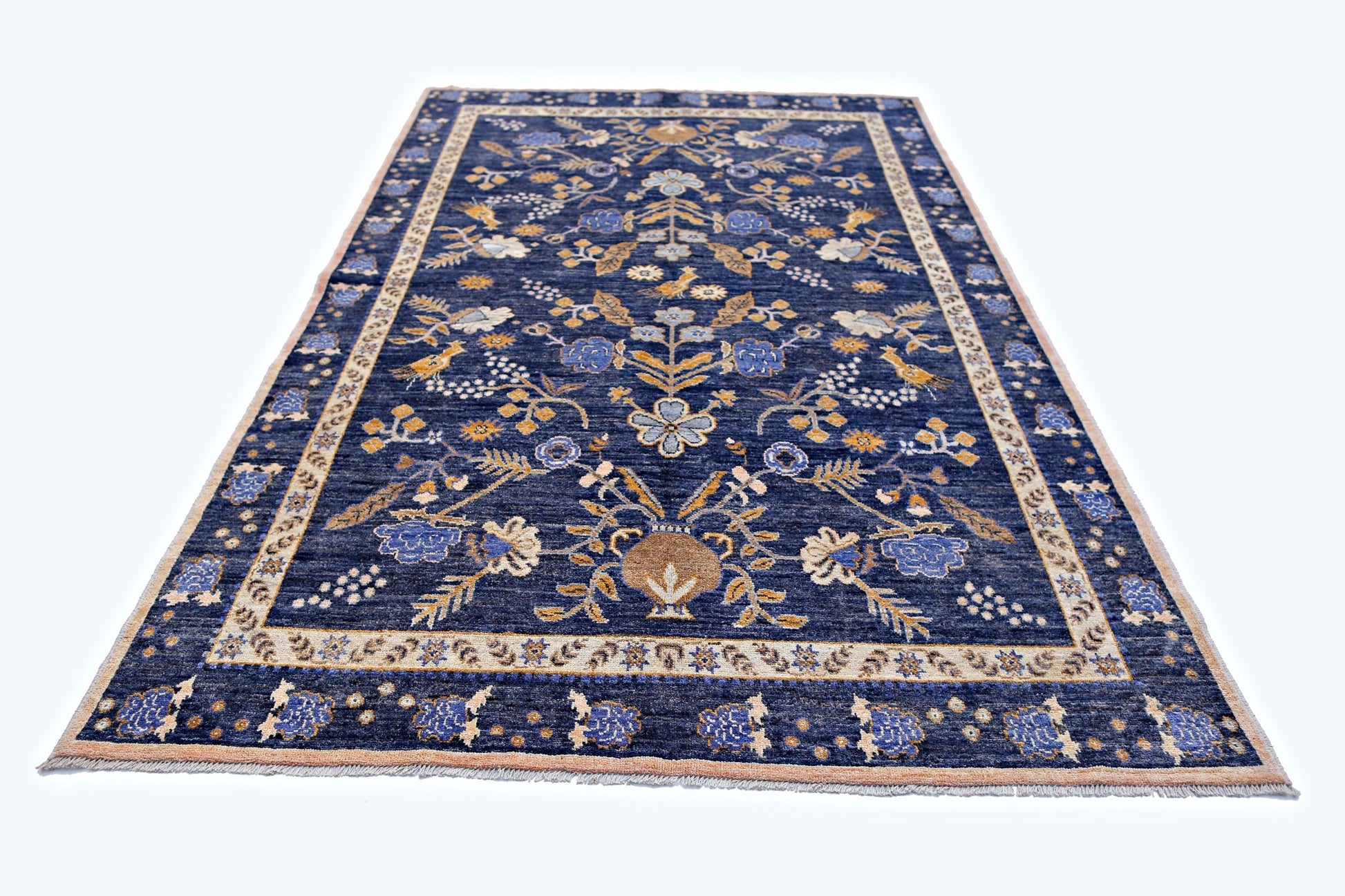 Handmade Afghan Pashm wool rug featuring a floral pattern in blue, tan, and cream tones.