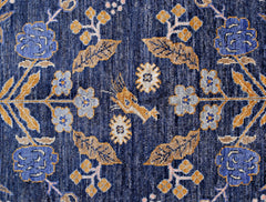 Handmade Afghan Pashm wool rug featuring a symmetrical floral pattern in blue, gold, and cream.