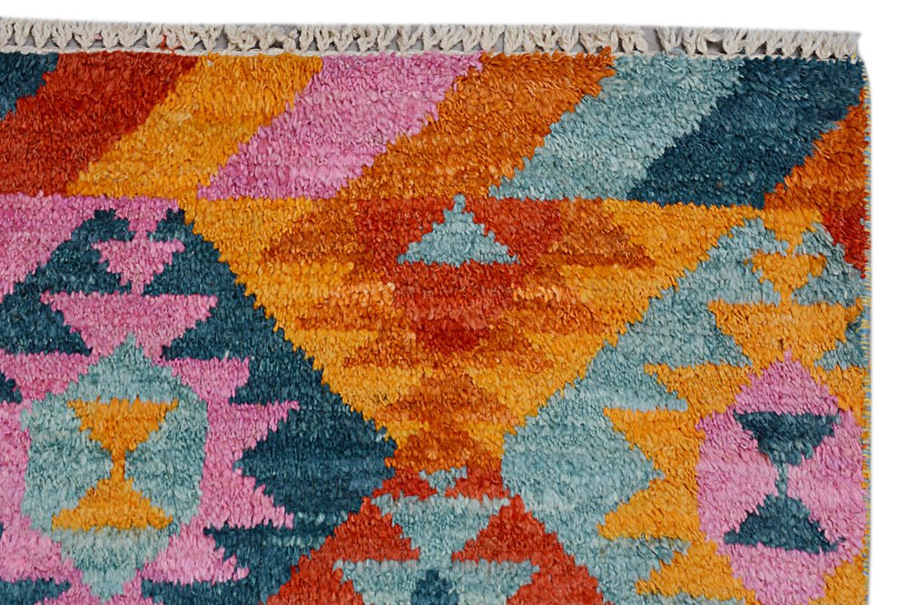 Handmade Afghan Pashm rug featuring a vibrant geometric pattern in orange, pink, and blue wool.