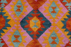 Handmade Afghan wool rug featuring a vibrant geometric diamond pattern in orange, pink, and blue.
