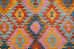 Handmade Afghan wool rug featuring a geometric diamond pattern in orange, pink, and blue.