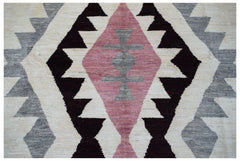 Handmade Afghan wool rug featuring a geometric diamond pattern in pink, grey, and dark brown.
