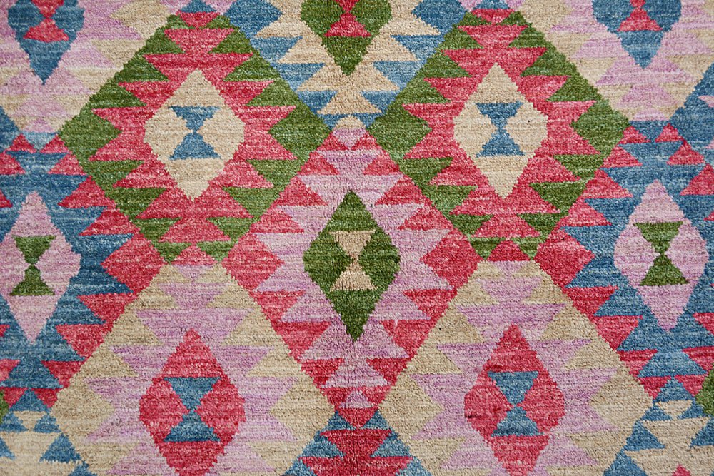 Handmade Afghan wool rug featuring a vibrant geometric diamond pattern in pink, green, and blue.