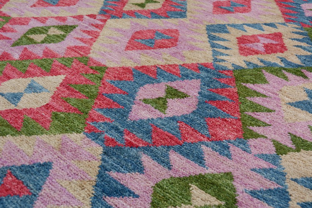 Handmade Afghan wool rug featuring a colorful geometric pattern in pink, blue, and green.
