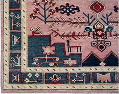 Handmade Afghan wool rug featuring a pink field with blue geometric floral and animal motifs.