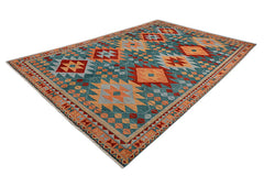 A handmade Afghan wool rug featuring a geometric pattern in teal, orange, and red tones.