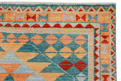 A handmade Afghan Pashm rug featuring a geometric pattern in teal, orange, and red wool.