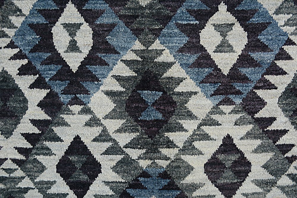 Handmade Afghan wool rug featuring a geometric diamond pattern in shades of blue, grey, and black.