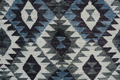 Handmade Afghan wool rug featuring a geometric diamond pattern in shades of blue, grey, and black.