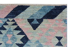 Handmade Afghan Pashm rug featuring a geometric pattern in shades of blue, pink, and cream.