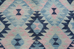 Handmade Afghan wool rug featuring a geometric diamond pattern in shades of blue and soft pink.