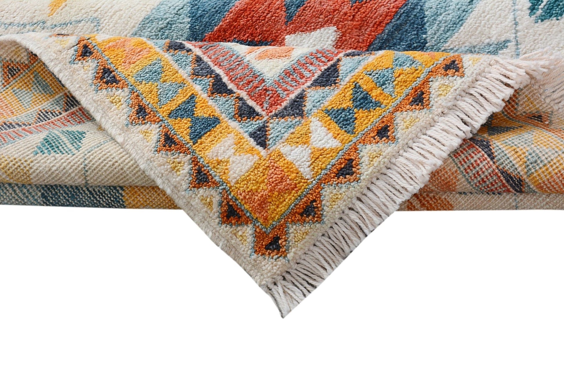 A handmade Afghan wool rug featuring a colorful geometric tribal pattern and fringed edges.