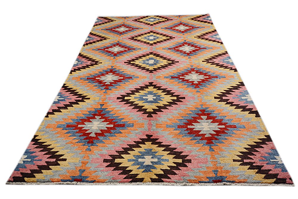 Handmade Afghan wool rug featuring a colorful geometric diamond pattern on a light background.
