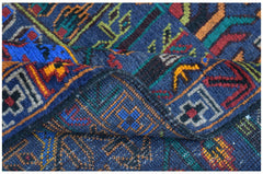A handmade Afghan wool runner featuring a blue background with intricate geometric hunting motifs.