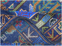 A close-up of a handmade Afghan wool runner featuring a blue background with intricate patterns.
