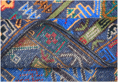 A handmade Afghan wool runner featuring a blue background with intricate geometric hunting motifs.
