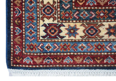 A close-up of an Afghan Super Kazakh rug featuring traditional geometric patterns in red and blue.