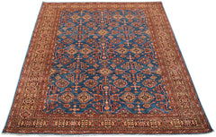 Handmade Afghan Super Kazakh rug featuring a traditional geometric pattern on a blue field.