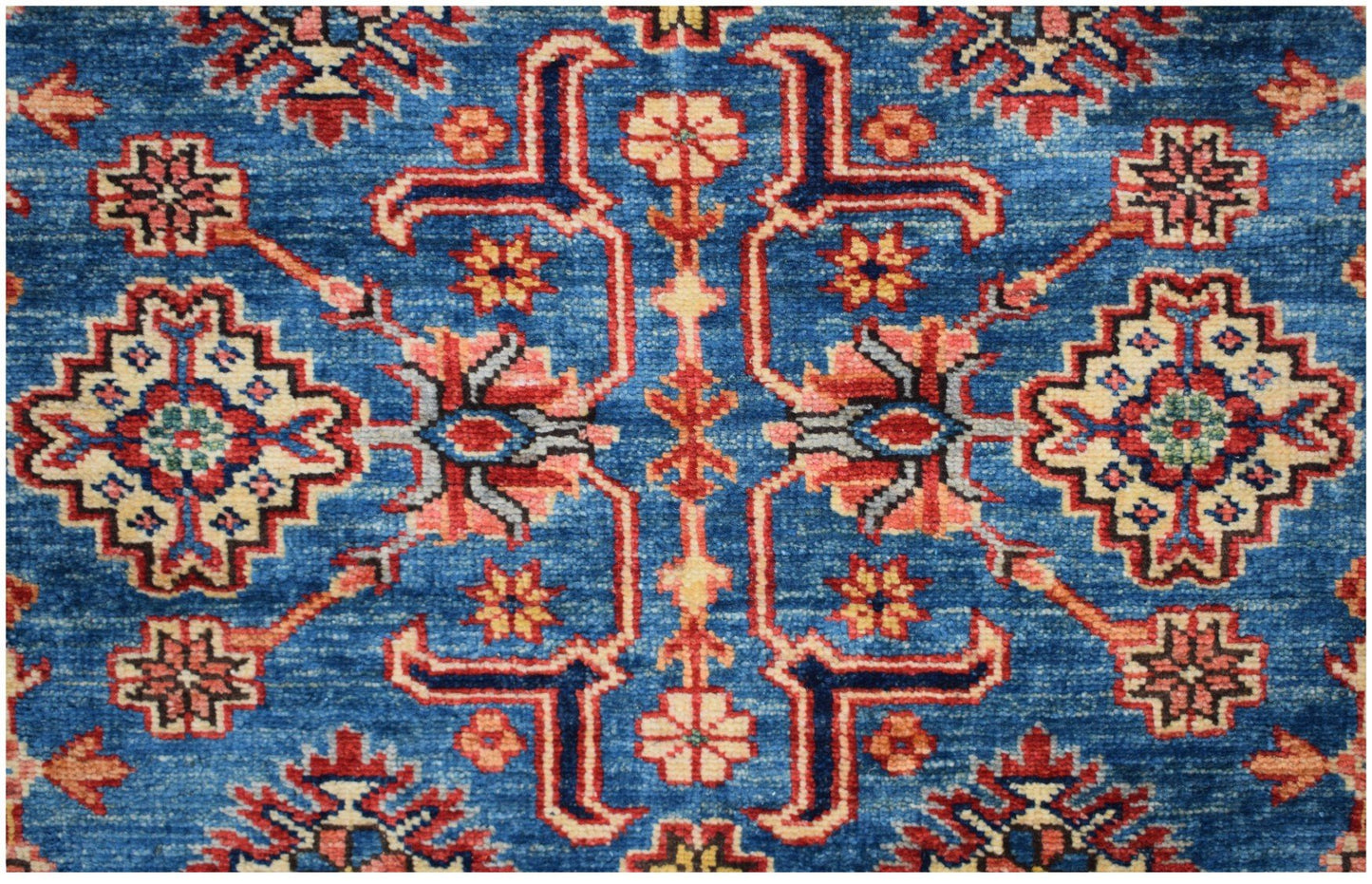 Handmade Afghan Kazakh rug featuring a geometric floral pattern in red, cream, and blue tones.