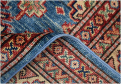 A handmade Afghan Super Kazakh rug featuring a blue field with traditional geometric patterns.