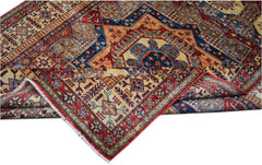 A handmade Afghan Super Kazakh rug featuring a geometric pattern in red, blue, and cream tones.