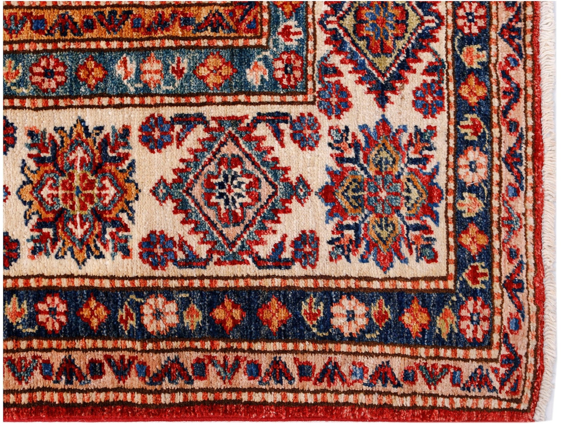 A handmade Afghan Super Kazakh rug featuring traditional geometric motifs in red, blue, and cream.