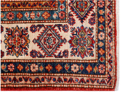 A handmade Afghan Super Kazakh rug featuring traditional geometric motifs in red, blue, and cream.