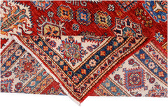 A handmade Afghan Super Kazakh rug featuring traditional geometric motifs in red, blue, and cream.