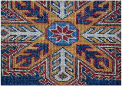 A close-up of an Afghan Super Kazakh rug featuring a central red star motif on a blue background.