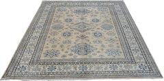 A handmade Afghan Super Kazakh rug featuring traditional blue geometric motifs on a beige field.