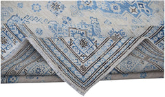A handmade Afghan Super Kazakh rug featuring traditional blue and cream geometric patterns.