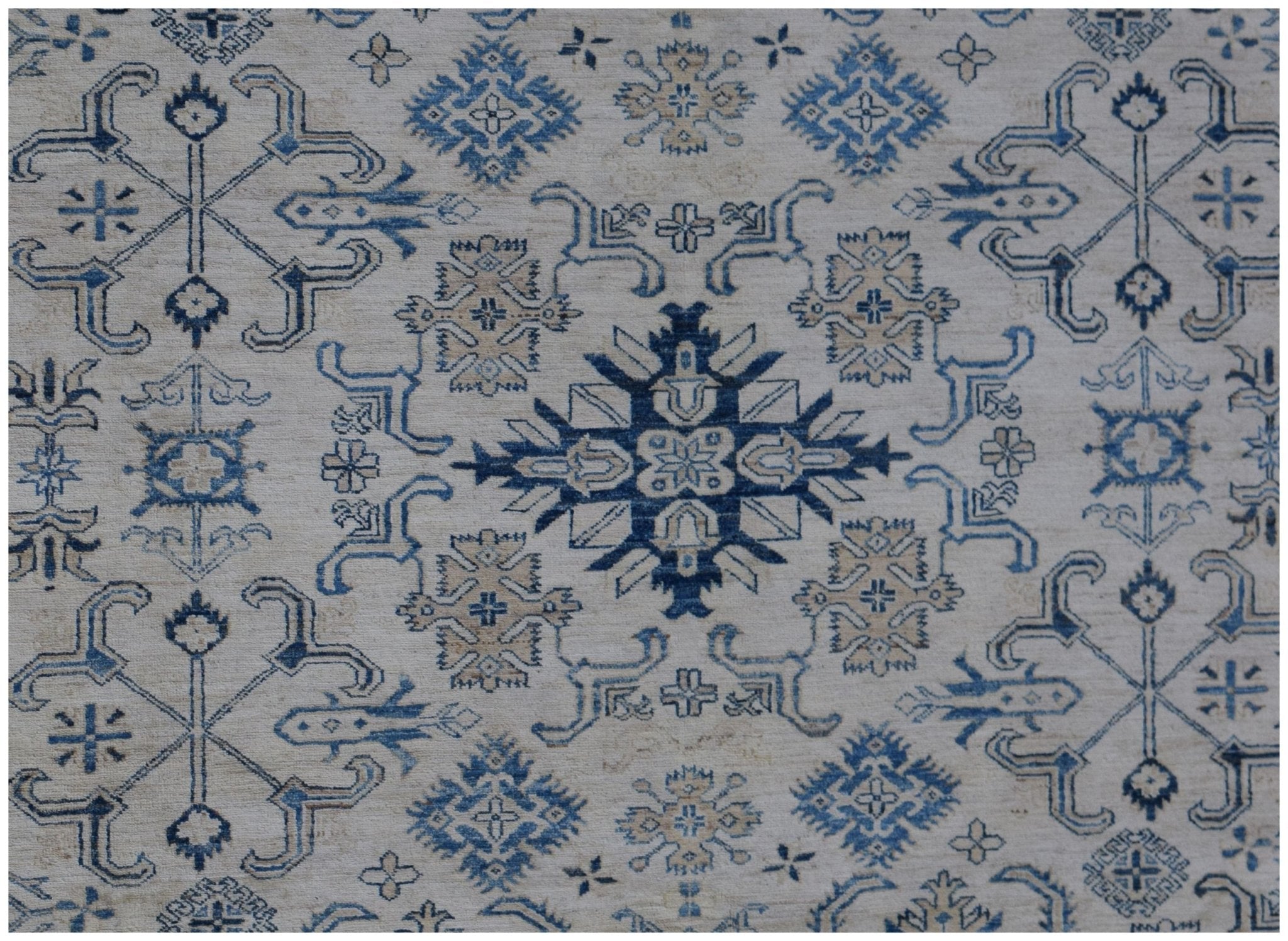 Handmade Afghan Super Kazakh rug featuring traditional blue and beige geometric motifs.
