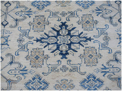 An Afghan Super Kazakh rug featuring a central blue geometric medallion on a cream wool background.