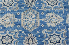 Handmade Afghan Super Kazakh rug featuring traditional geometric motifs in blue and cream wool.