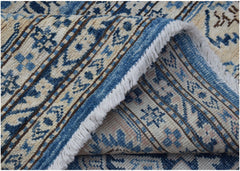 A handmade Afghan Super Kazakh rug featuring traditional blue and cream geometric patterns.