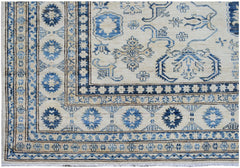 Handmade Afghan Super Kazakh rug featuring traditional blue geometric motifs on a cream background.