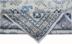 An Afghan Super Kazakh rug featuring traditional blue floral motifs on a cream wool background.