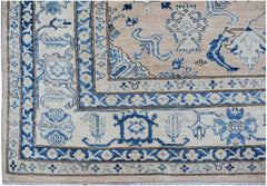 Handmade Afghan Super Kazakh rug featuring a beige field with intricate blue geometric patterns.