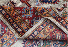 A hand-knotted Afghan Super Kazakh rug featuring traditional geometric motifs in vibrant colors.