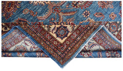 A handmade Afghan Super Kazakh rug featuring traditional blue, red, and cream geometric patterns.