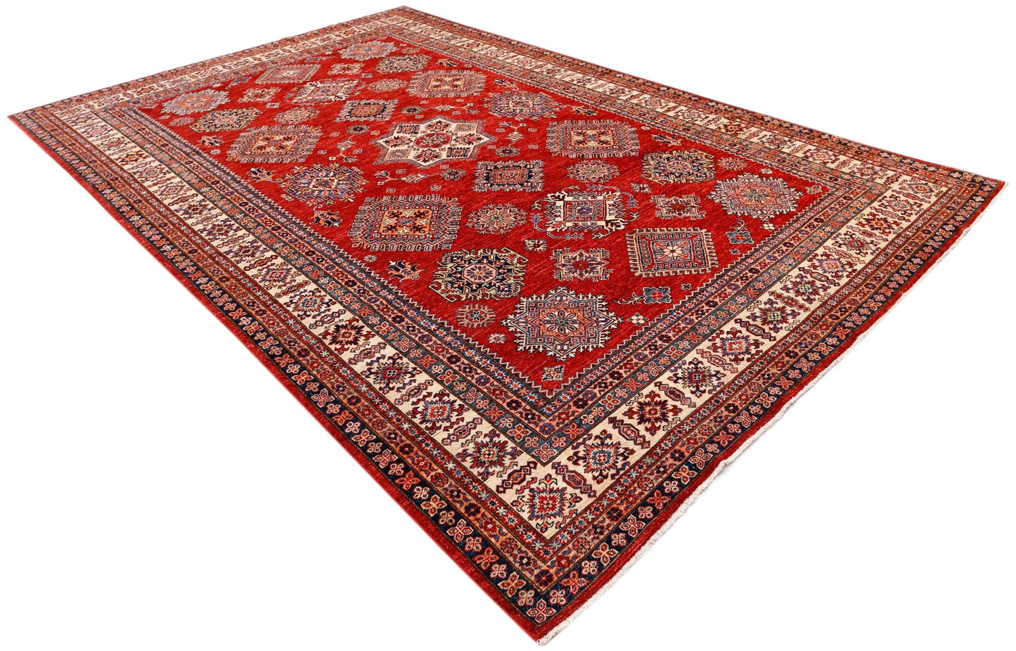 A handmade Afghan Super Kazakh rug featuring traditional geometric motifs on a vibrant red field.