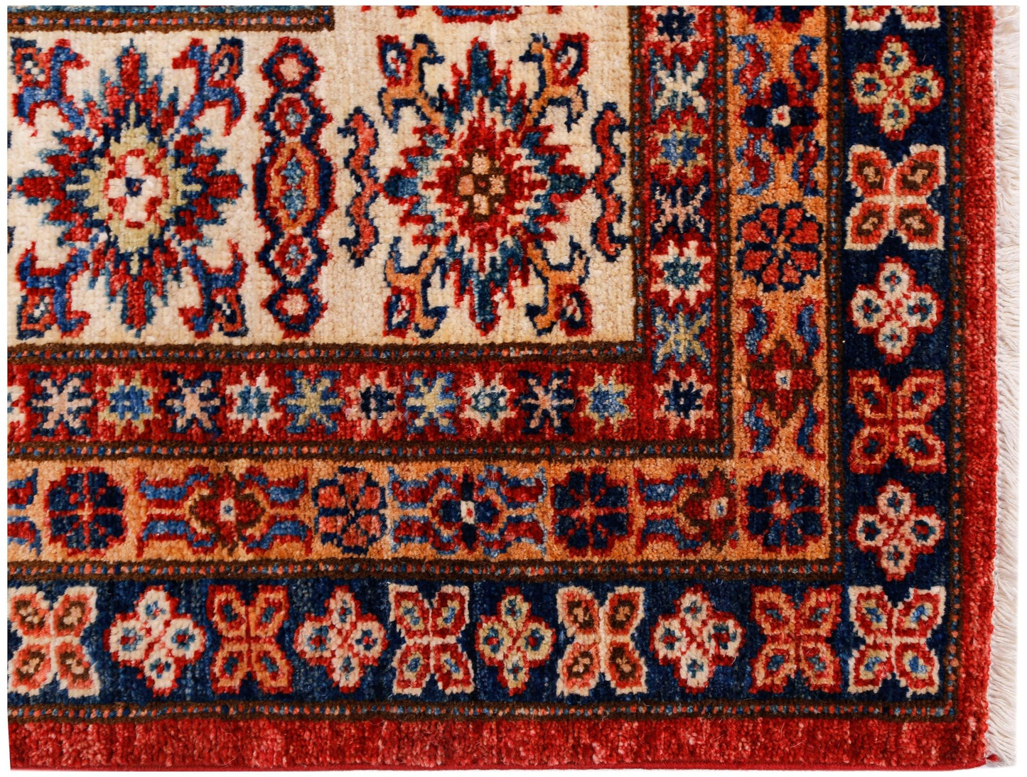 A handmade Afghan Super Kazakh rug featuring traditional geometric motifs in red, blue, and cream.