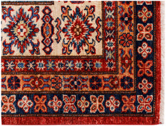 A handmade Afghan Super Kazakh rug featuring traditional geometric motifs in red, blue, and cream.