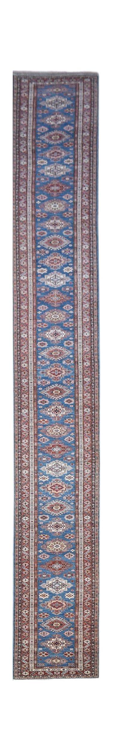 A long, handmade Afghan Super Kazakh runner rug featuring traditional geometric motifs in blue.